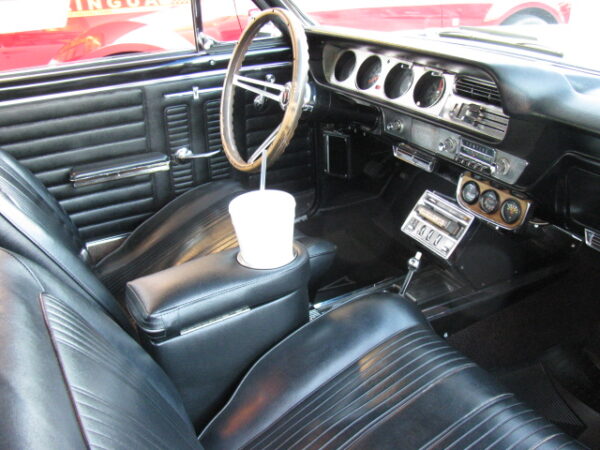 A Pontiac Lemans/GTO Armrest and Drink Holder in Car Side View
