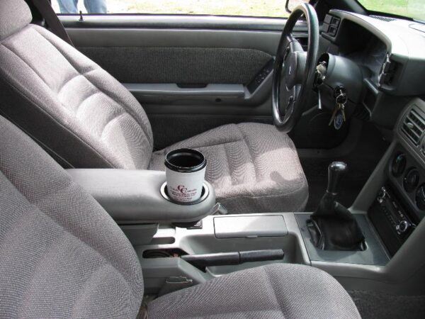 A 1987-1993 Ford Mustang Armrest Cup Holder