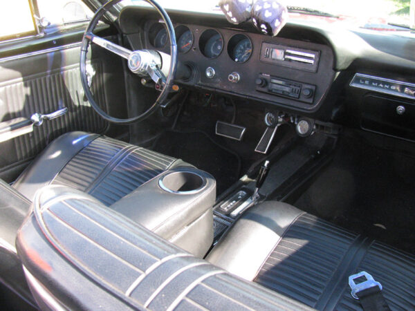A Pontiac Lemans/GTO Armrest and Drinkholder in Car